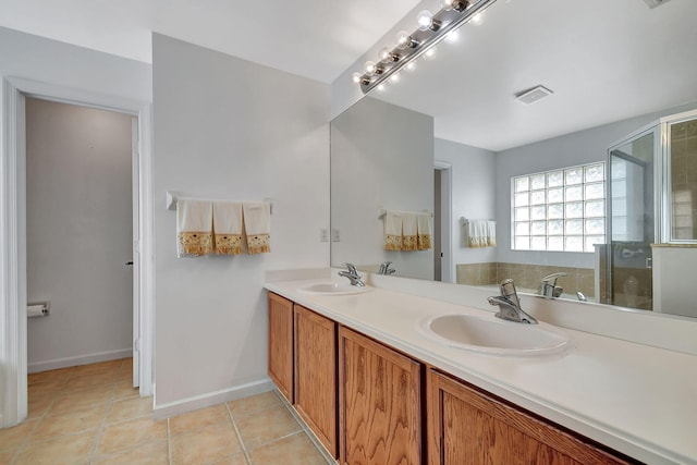 bathroom featuring tile patterned flooring, vanity, and a shower with shower door