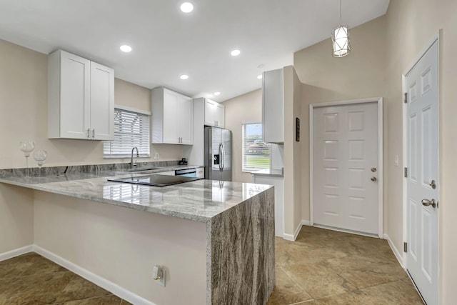 kitchen featuring hanging light fixtures, stainless steel refrigerator with ice dispenser, sink, white cabinetry, and kitchen peninsula