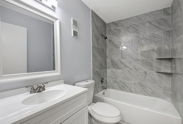 full bathroom with vanity, tiled shower / bath combo, and toilet