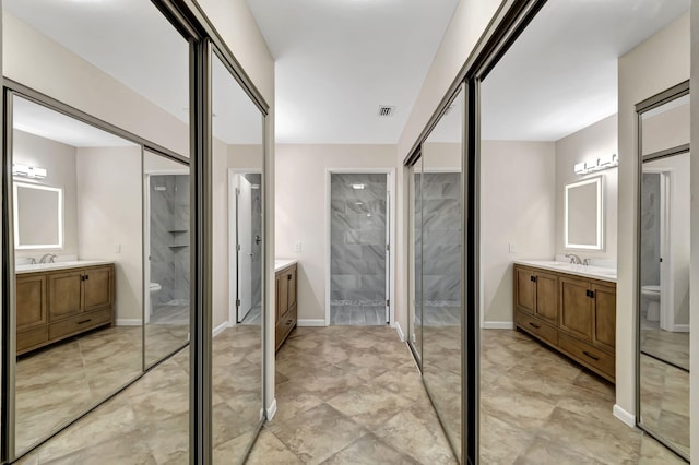 bathroom featuring vanity, toilet, and an enclosed shower