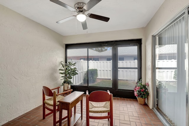 sunroom featuring ceiling fan