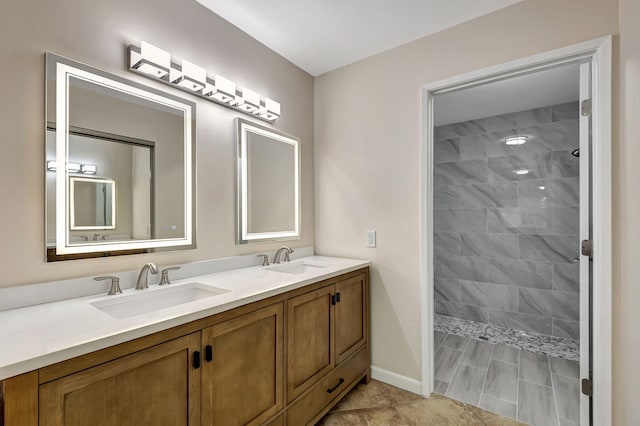 bathroom with a tile shower and vanity