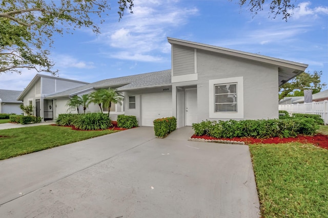 view of front of home with a front yard and a garage