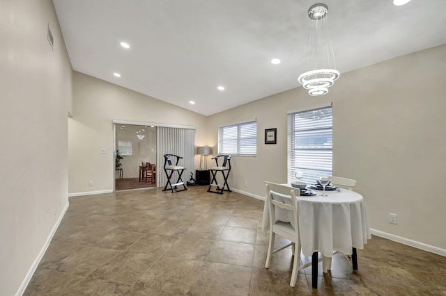 dining space featuring vaulted ceiling and a chandelier