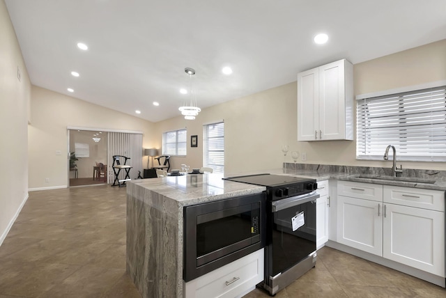 kitchen featuring black microwave, stainless steel range with electric cooktop, sink, white cabinetry, and lofted ceiling