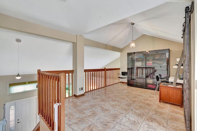 hallway featuring vaulted ceiling and light tile patterned flooring