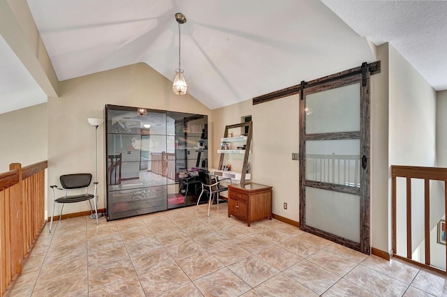 interior space with light tile patterned floors, a barn door, baseboards, and vaulted ceiling