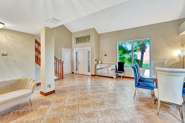 foyer featuring light tile patterned floors, stairway, visible vents, and baseboards