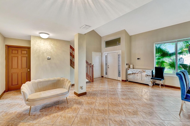 entrance foyer with stairs, light tile patterned flooring, visible vents, and baseboards