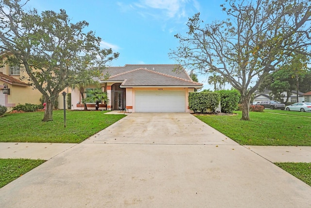 view of front of property with a front lawn and a garage