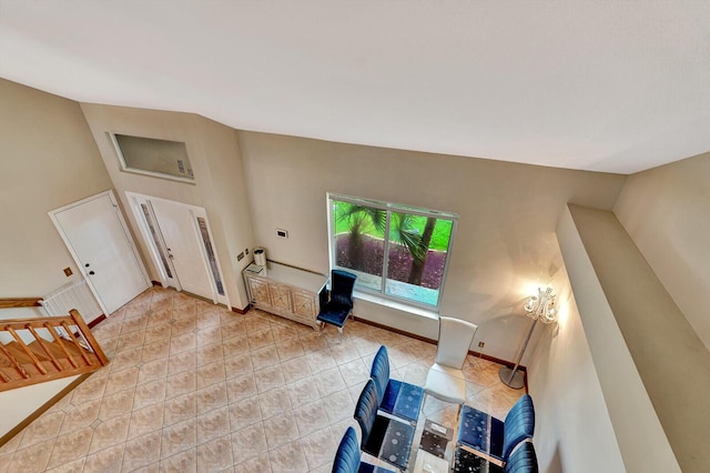 living room featuring high vaulted ceiling and light tile patterned floors