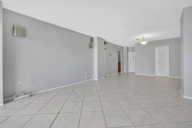 unfurnished room featuring light tile patterned flooring