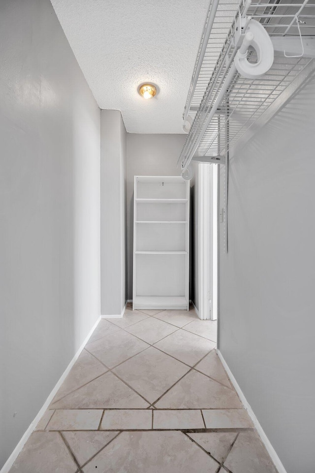 hallway with light tile patterned floors