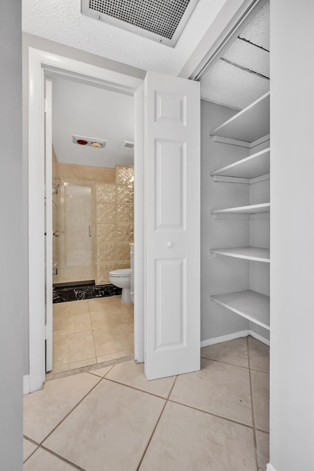 hallway with tile patterned floors