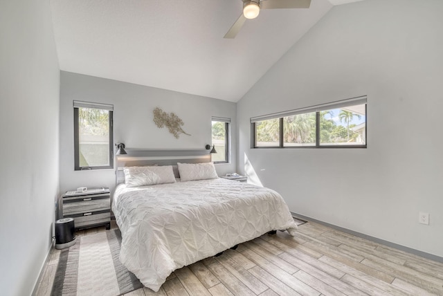 bedroom featuring ceiling fan, light hardwood / wood-style floors, and high vaulted ceiling