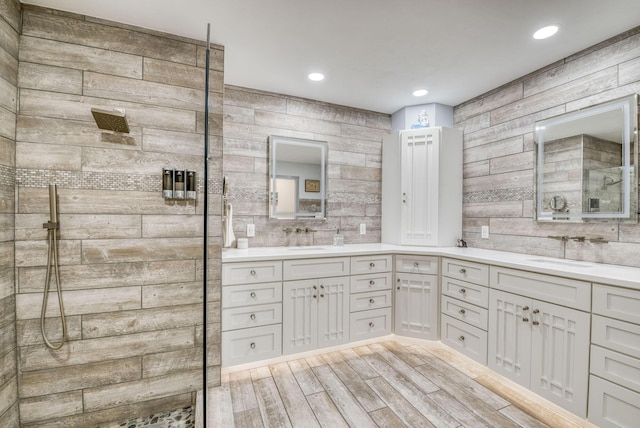 bathroom with vanity, a shower, and wood-type flooring