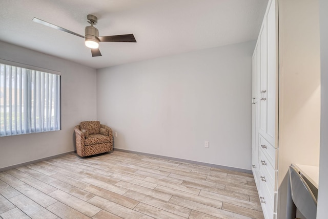 living area with ceiling fan and light hardwood / wood-style floors