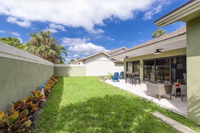 view of yard with a patio area and ceiling fan