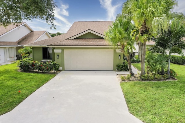 view of front facade featuring a front yard and a garage