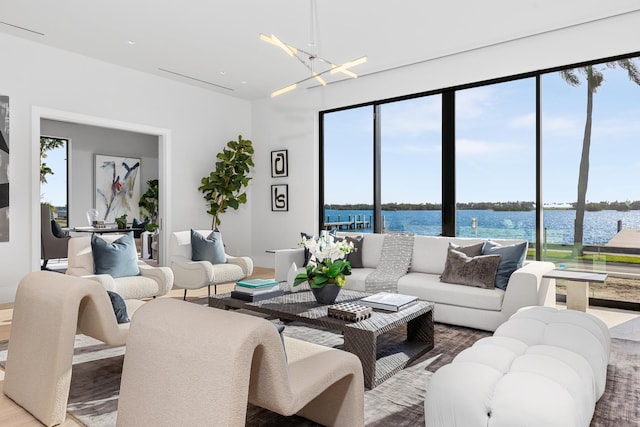 living room featuring hardwood / wood-style floors, a water view, and a wealth of natural light