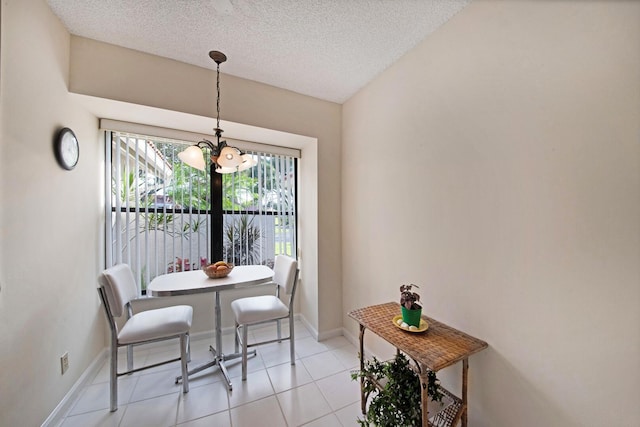 dining area with vaulted ceiling, light tile patterned floors, a textured ceiling, and a notable chandelier