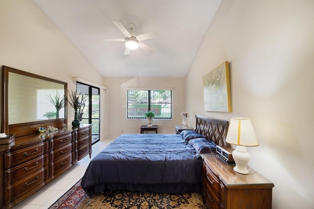 bedroom featuring ceiling fan, light tile patterned floors, and vaulted ceiling