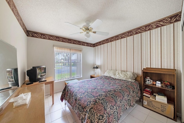 tiled bedroom featuring ceiling fan and a textured ceiling