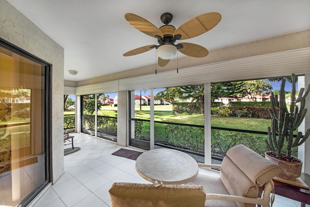 sunroom / solarium featuring ceiling fan