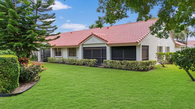 back of house with a lawn