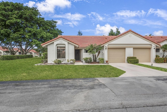 view of front of house featuring a garage and a front lawn