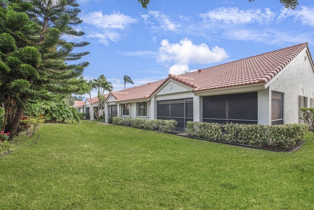 rear view of property featuring a yard