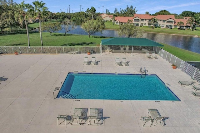 view of pool with a water view and a patio