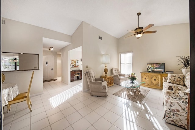 tiled living room featuring high vaulted ceiling and ceiling fan