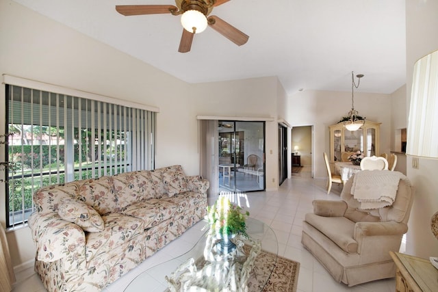 tiled living room featuring ceiling fan and vaulted ceiling