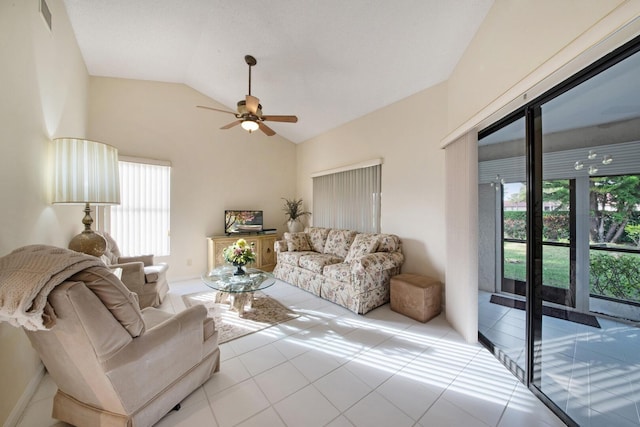 tiled living room with plenty of natural light, ceiling fan, and lofted ceiling