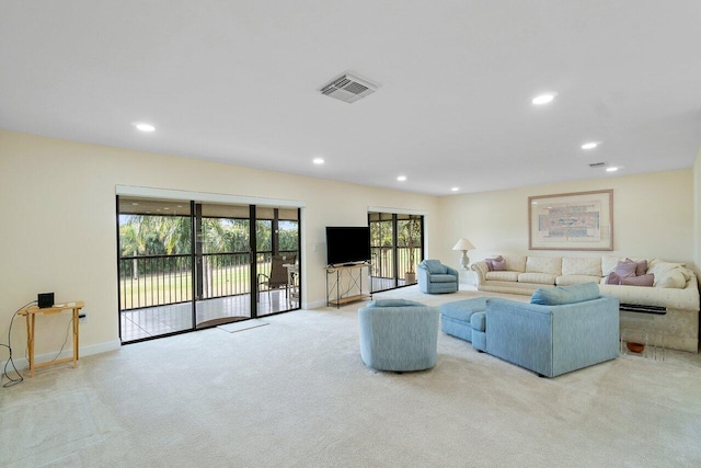 living room with light colored carpet and a wealth of natural light