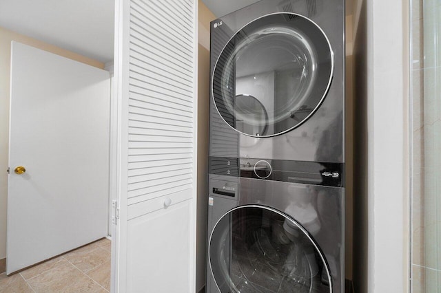 washroom featuring stacked washing maching and dryer