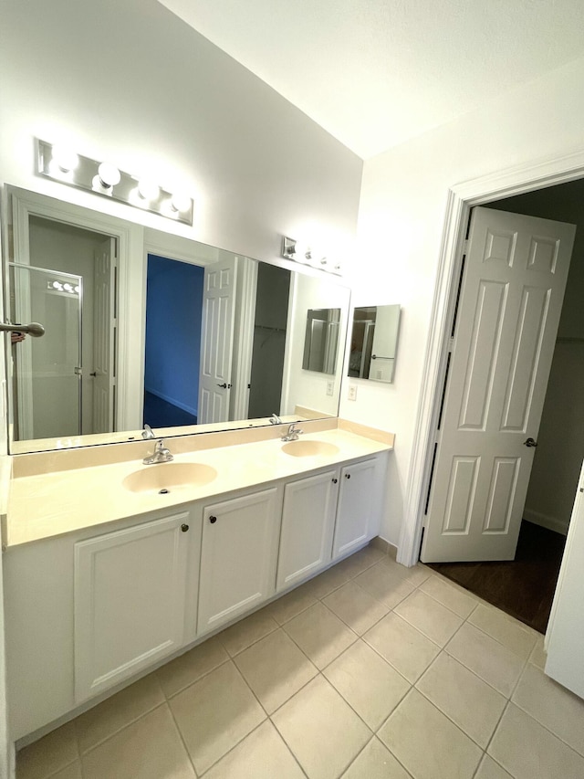 bathroom with tile patterned flooring and vanity