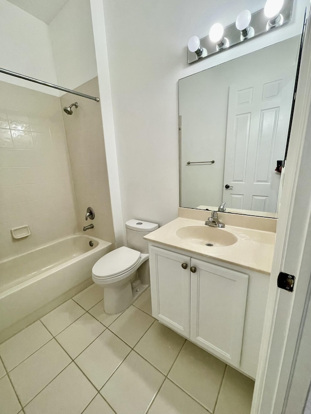 full bathroom with tile patterned floors, tiled shower / bath combo, toilet, and vanity