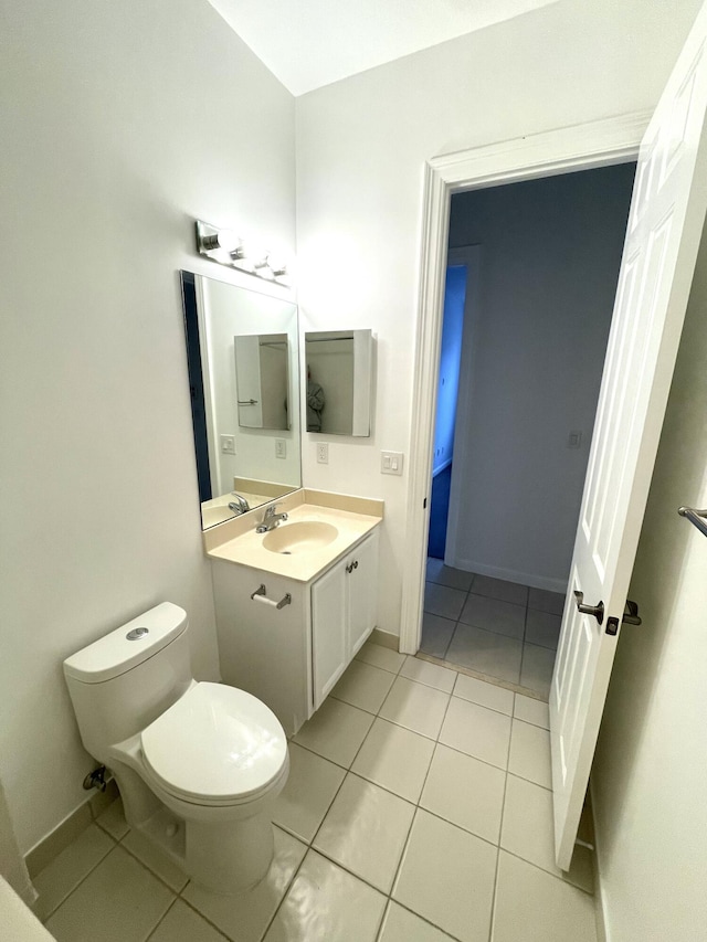 bathroom featuring tile patterned flooring, vanity, and toilet