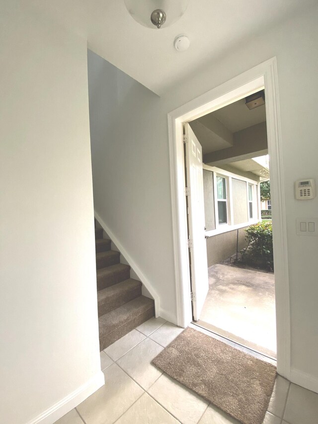 staircase featuring tile patterned flooring