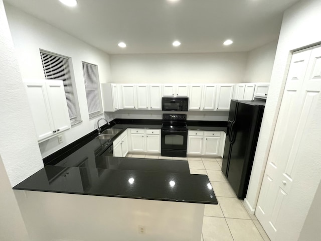 kitchen featuring kitchen peninsula, sink, black appliances, light tile patterned floors, and white cabinets