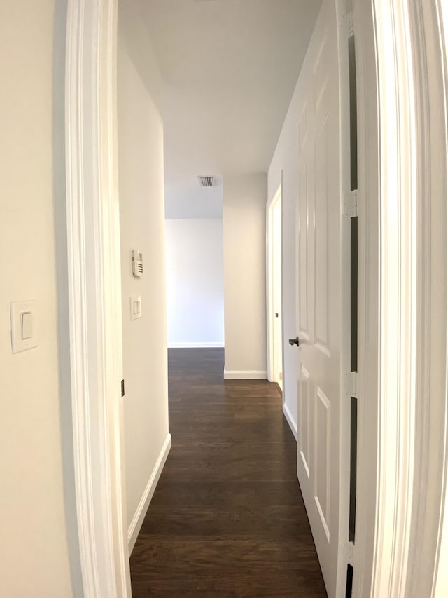 hallway with dark wood-type flooring