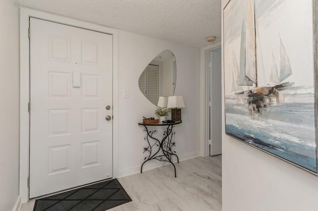 foyer entrance featuring a textured ceiling