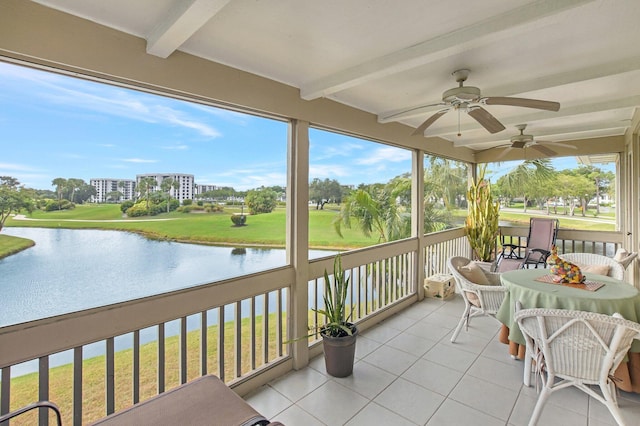 sunroom / solarium with ceiling fan, beam ceiling, and a water view