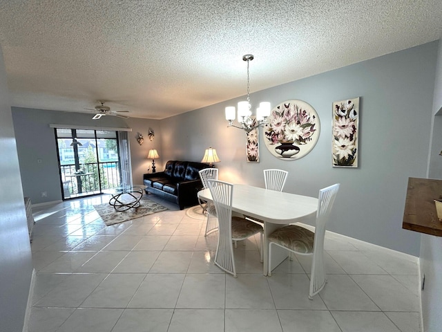 dining space featuring a textured ceiling, ceiling fan with notable chandelier, and light tile patterned flooring