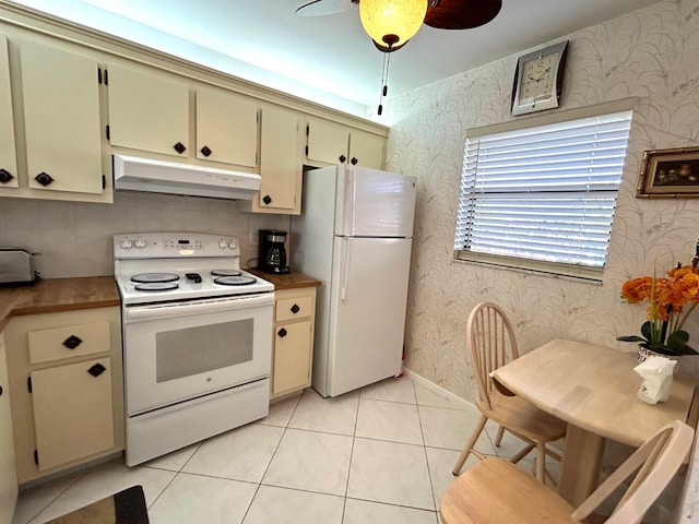 kitchen featuring cream cabinetry, light tile patterned floors, white appliances, and ceiling fan