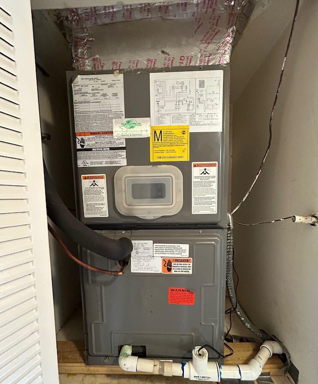 utility room featuring heating unit