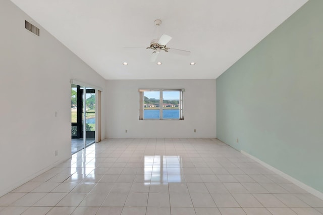 tiled empty room with ceiling fan and lofted ceiling