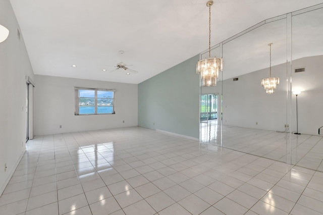 spare room with light tile patterned flooring and ceiling fan with notable chandelier